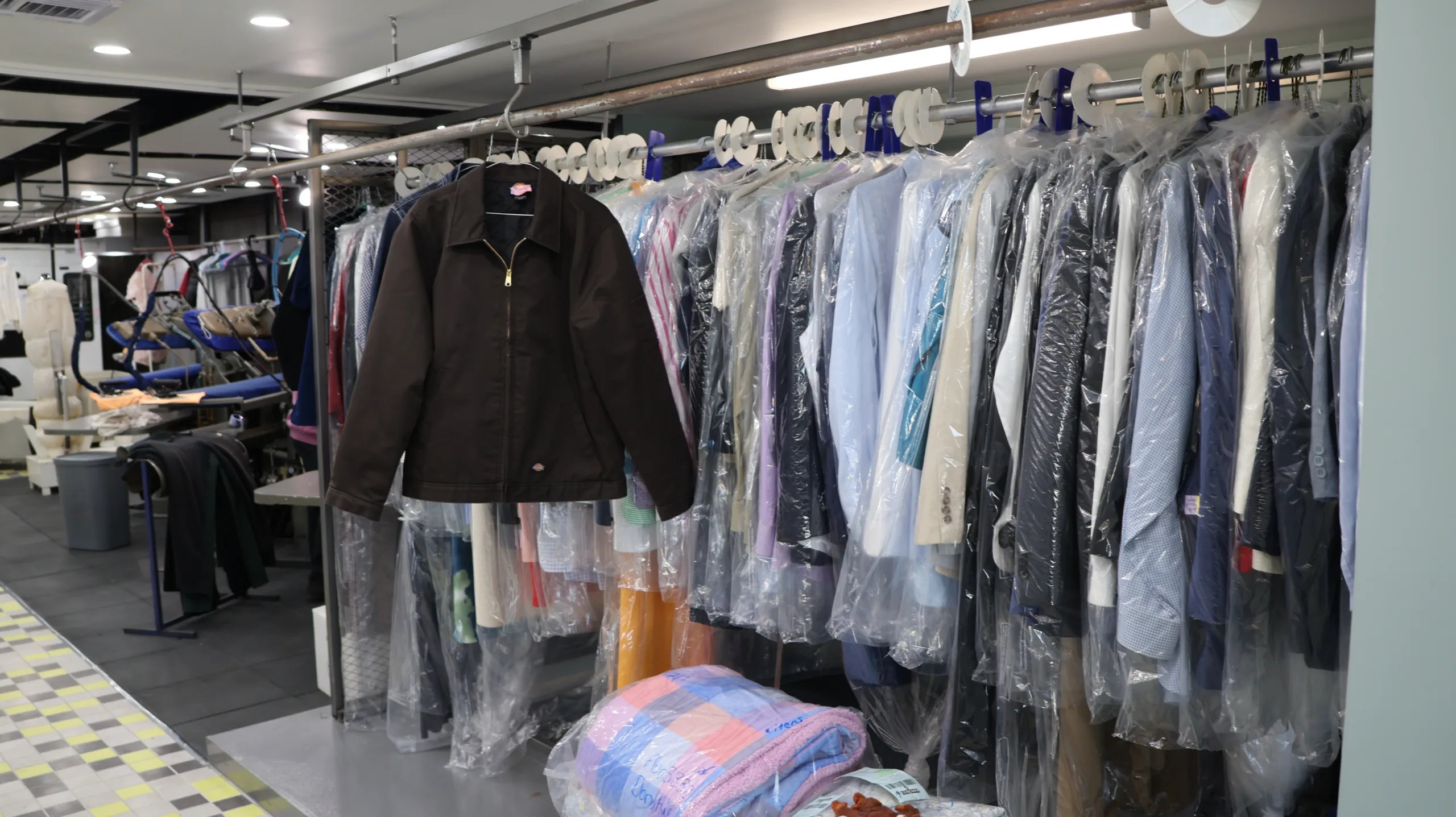 peninsula dry cleaning clothes stored on rack