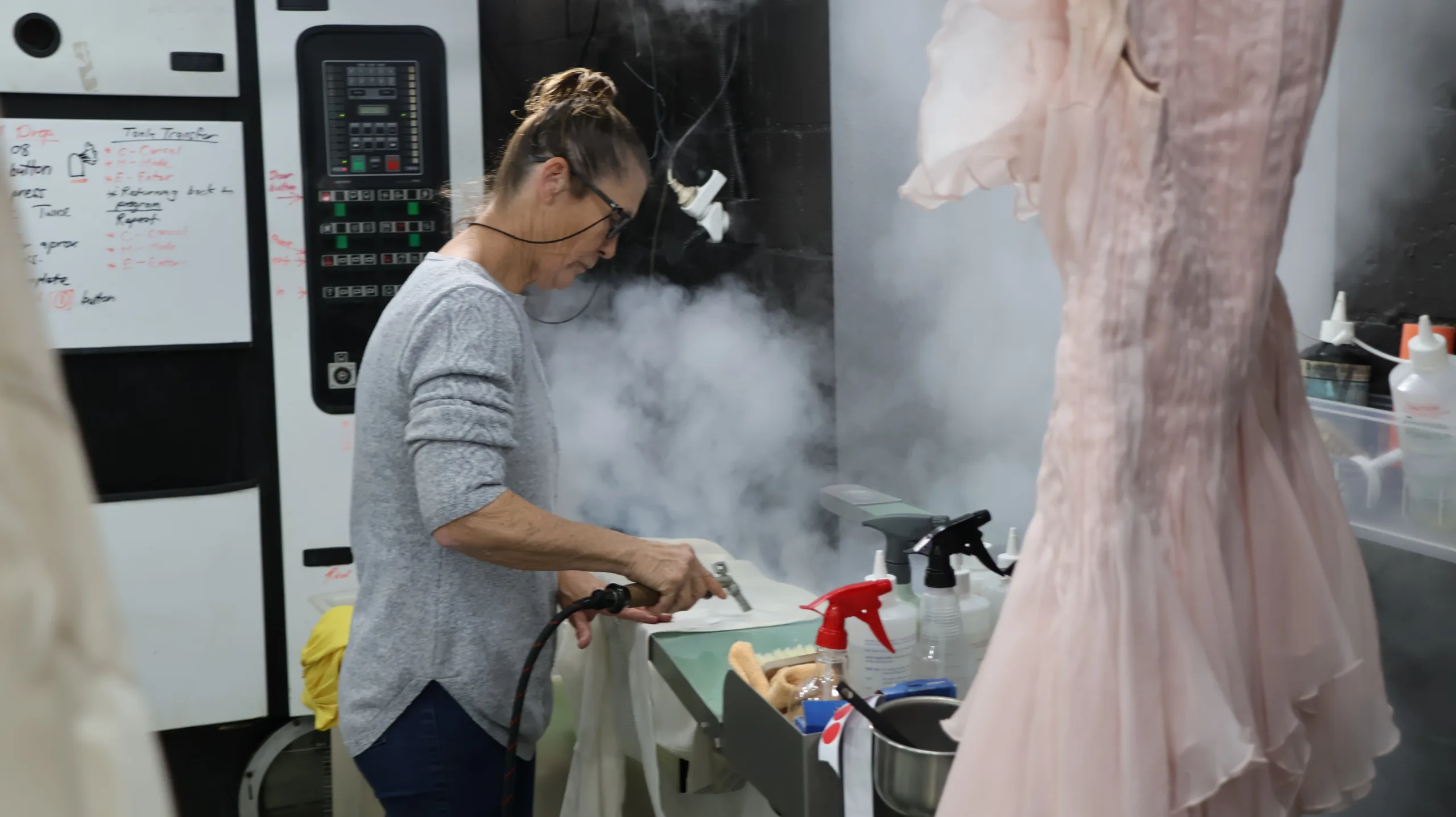 peninsula dry cleaning staff with steamer machine on clothing